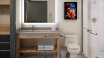 Un baño moderno con un espejo grande, un lavabo, un inodoro y una ducha.