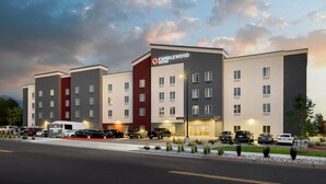 A multi-story hotel with a modern design, featuring a prominent "Candlewood Suites" sign.