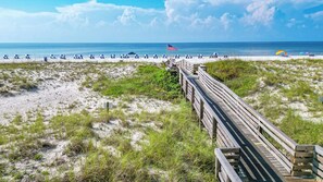 A beach with a wooden boardwalk leading to beach chairs and umbrellas. - Emerald Isle 3B Gulf Front Unit 308 - Sleeps 8! (Pensacola Beach)