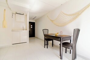 Enjoy meals in style with a dining table for two, a comfortable chair, and a convenient cabinet for storage.