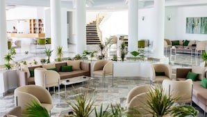 A spacious lobby with multiple seating areas, a staircase, and a reception desk. - Sandra Beach Mahdia (Mahdia)