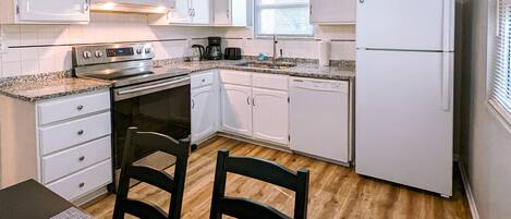 Fridge, stovetop, dishwasher, coffee/tea maker