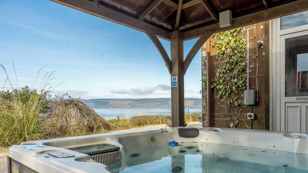 A hot tub with a view of the sea, a covered area, and a 'Quiet Please' sign. - The Old Nunnery - UK7122 (Skelmorlie, near Largs)