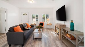 A living room with a sofa, coffee table, and TV.