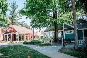 A storefront with a sign reading "Timberline Shop" and a building with a sign that says "Shanty". - Northern Nights Chalet Wanderlust Abodes (Bellaire)