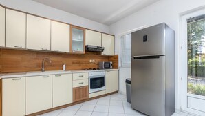 A modern kitchen with a stainless steel refrigerator, a microwave, and a built-in oven. - Stunning apartment in Spincici with WiFi (Spincici)