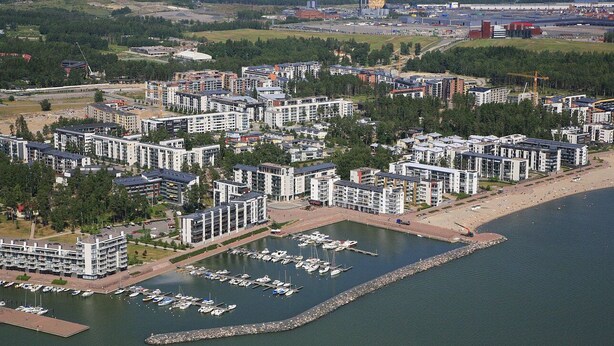 A coastal residential area with modern apartment buildings, a marina with boats, and a beach. - Nice apartment with sea view<br> (Helsinki)