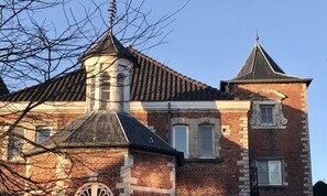 A historic building with a prominent tower and a brick facade.