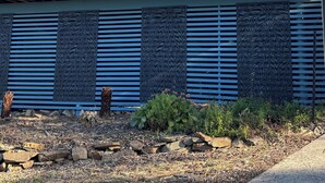 A modern building with a balcony, large windows, and a decorative wall panel. - Peaceful -Local Wine & Tamar River Views/Pets Allowed (Clarence Point)