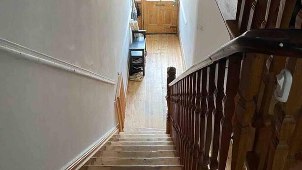 A wooden staircase with a handrail leading to a door with a window. - Edwardian Villa by the Sea,coastal Walks,king Beds (Walton on the Naze)