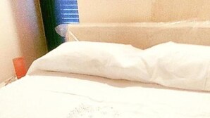 A neatly made bed with a folded white towel. - Mary's Niche (Bisceglie)
