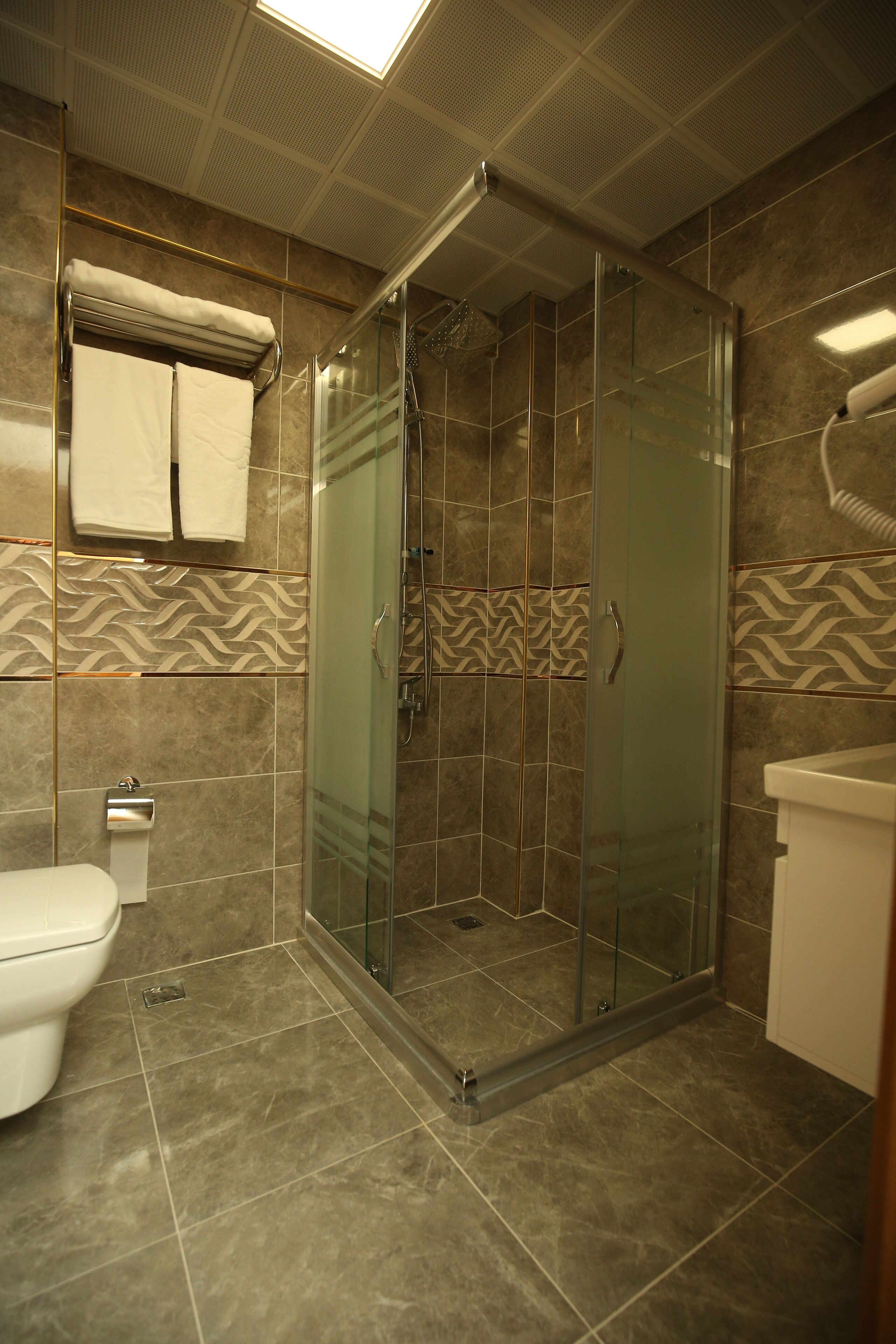 Economy Double Room Single Use, 1 Queen Bed, City View | Bathroom | Shower, rainfall showerhead, hair dryer, slippers