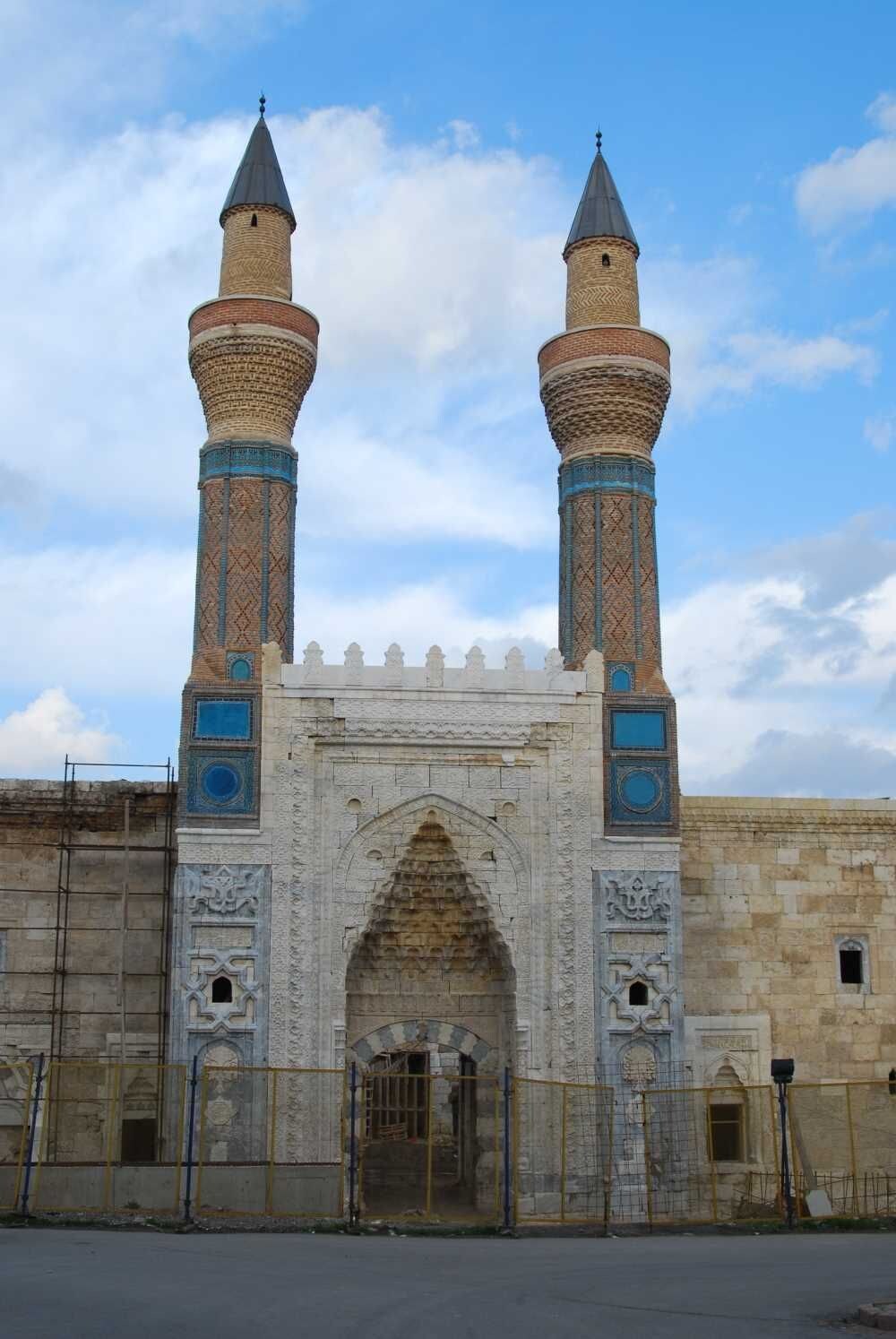 A historic building with two prominent towers and a central archway.