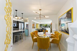 Enjoy meals in this inviting dining area with a central table and stylish seating.