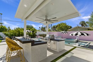 Enjoy a meal at the kitchen island or relax by the pool with lounge chairs and umbrellas.