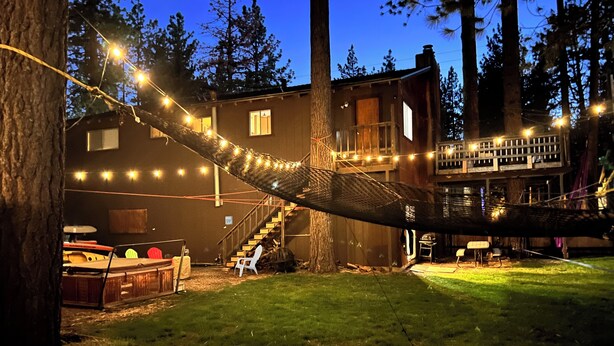 A house with a deck, a hammock, and string lights. - Enjoy a Cottage near the lake 2bdr, Tahoe 2Bdr Postmasters Cottage (South Lake Tahoe)