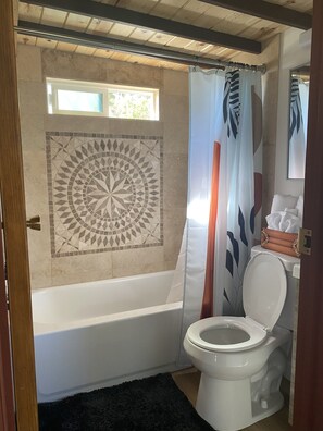 Combined shower/bathtub, hair dryer, towels, soap