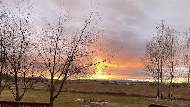 A wooden deck with a stone pathway leading to a grassy field. - Montana ranch house sunrise sunset views & fields (Bozeman)
