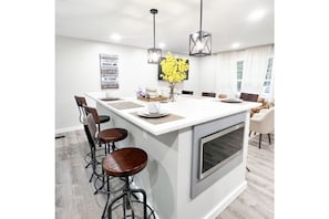 Enjoy cooking in this well-equipped kitchen with a central island and oven, perfect for preparing meals.