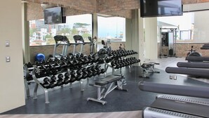 A gym with treadmills, dumbbells, and exercise equipment. - CONDO L268  BY TRVL2HM (Puerto Vallarta)
