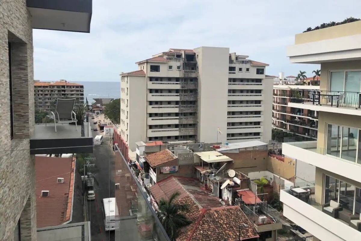 Ein Hochhaus mit mehreren Balkonen und Blick auf das Meer.
