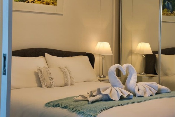 Luxuriously furnished master bedroom with our signature swans. Our apartment comes with Free Wifi, Netflix and Disney Plus