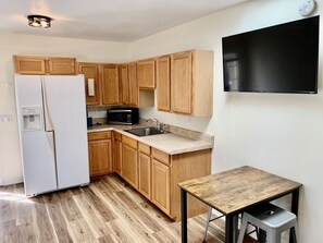 Full-size fridge, microwave, coffee/tea maker, cookware/dishes/utensils