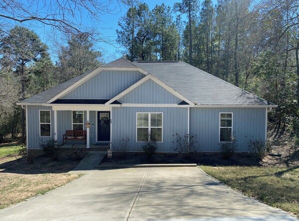 Stroll up to the charming single-story home with a gabled roof and inviting front porch.