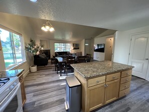 A modern kitchen with granite countertops, wooden cabinets, and a built-in oven. - Centrally Located OneLevel Pet ok Home w/Fireplace (Bend)