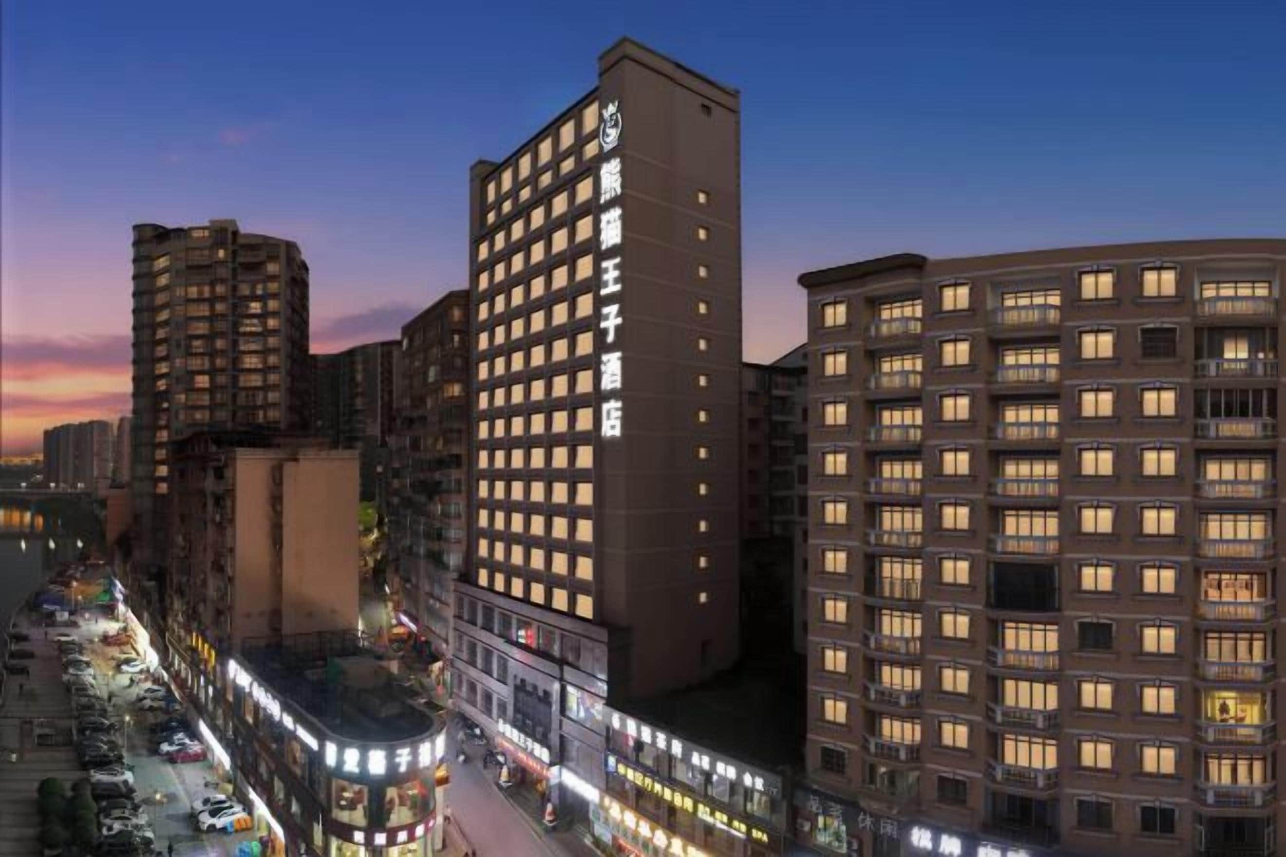 A multi-story hotel with a modern design, featuring a prominent entrance and a series of balconies.