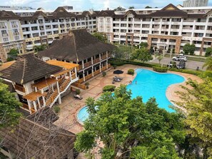Outdoor pool - Modern 2BR Condo Near SM with Free Parking, Pool, WIFI, and Netflix (Davao City)