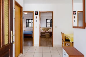 A room with a bed, a desk, and a chair. There are two doors leading to other rooms. - Apartments Frano (Trogir)