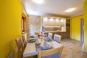 Enjoy meals in this dining area with a table set for four and a fully equipped kitchen.