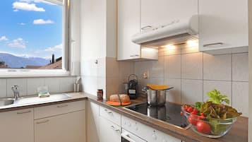 Family Apartment, 2 Bedrooms, Balcony (Castle view - Bellinzona) | Private kitchen | Coffee/tea maker, dining tables