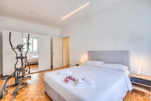 A hotel room with a bed, a treadmill, and a wardrobe. - Bellinzona Center (Bellinzona)