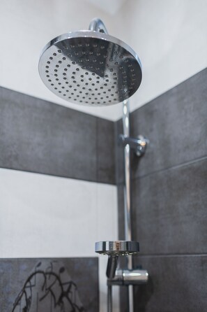 A showerhead with a circular, perforated design, mounted on a chrome fixture. - P&O Obozowa 2 (Warsaw)