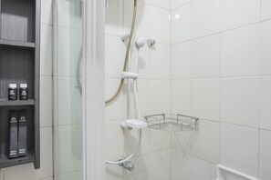 A shower area with a glass enclosure, a metal showerhead, and a white tiled wall. - Special 1Br Direct Pool Access At Thamrin Residence (Jakarta)