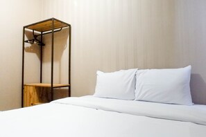 Comfortable bed and ample storage space in a stylish room.
