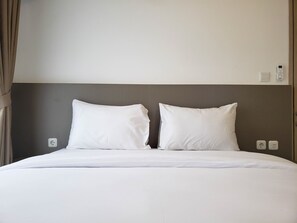 A neatly made bed with white linens, a dark headboard, and two bedside switches. - Nice And Elegant 2Br At 35Th Floor Tokyo Riverside Pik 2 Apartment (Teluknaga)