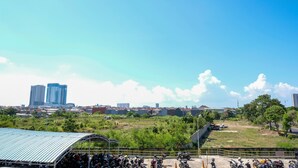 A parking area with multiple motorcycles and a covered structure. - Best Deal And Comfy Studio At Puncak Kertajaya Apartment (Surabaya)