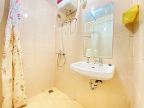 A bathroom with a shower, a sink, and a mirror. - Cozy Living 1Br Apartment At Parahyangan Residence (Bandung)