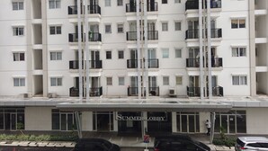 A multi-story hotel with a white facade, balconies, and a 'Summer Lobby' entrance. - Cozy And Tidy 2Br At Signature Park Grande Apartment (Jakarta)