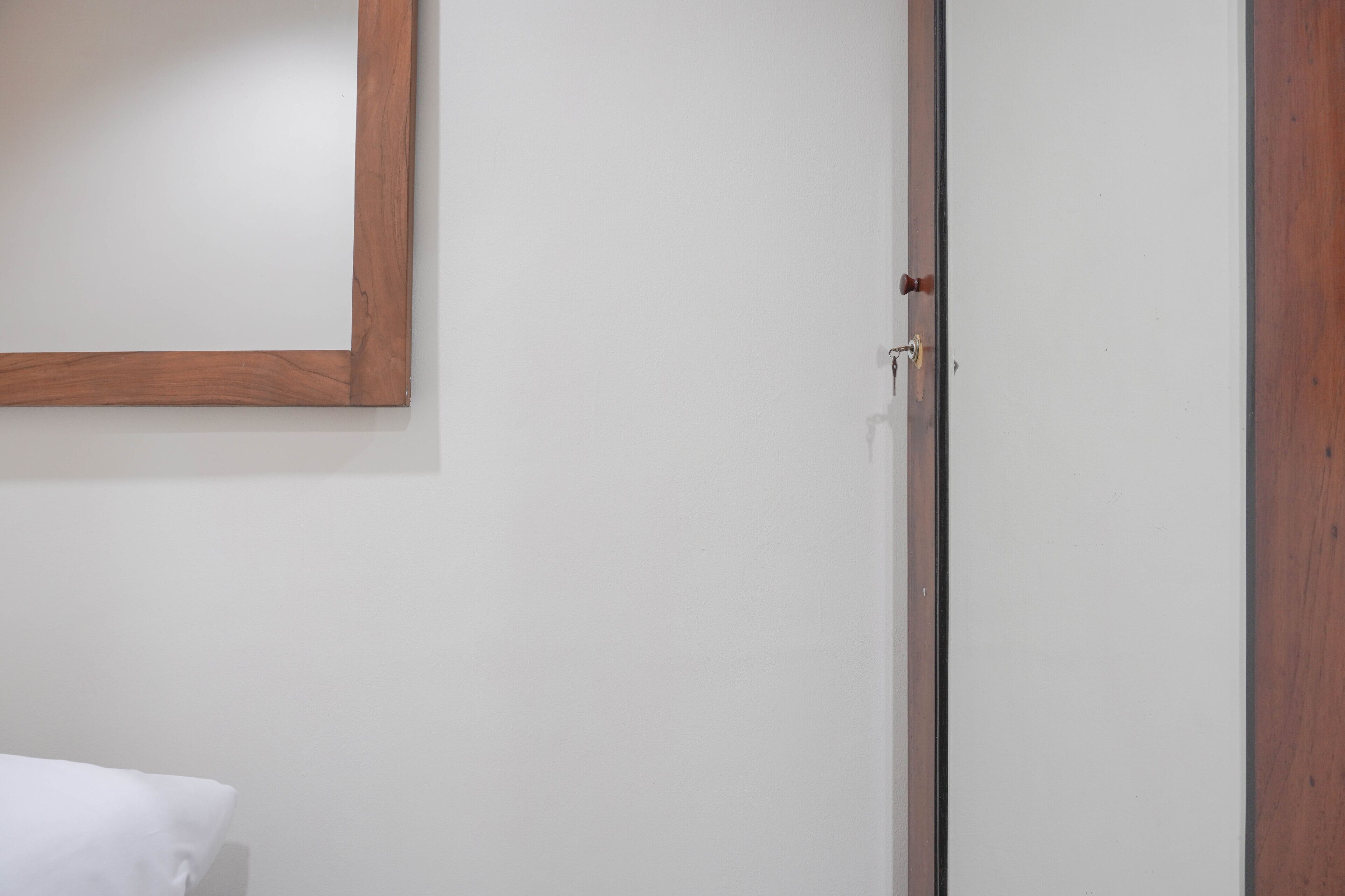 A white door with a wooden frame and a small window.
