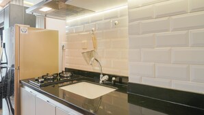 Una cucina moderna con lavello in acciaio inossidabile, piano cottura a gas e forno integrato.