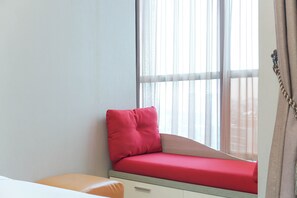 Relax in this serene room with a cozy window seat and comfortable bench.