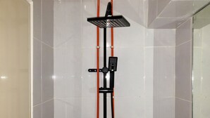 A shower with a handheld showerhead and a control panel. - Minimalist And Comfortable Studio Apartment Tokyo Riverside Pik 2 (Teluknaga)