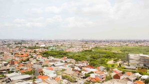 A residential area with houses and a modern building. - Fancy And Nice Studio @ Springlake Summarecon Bekasi Apartment (Bekasi)