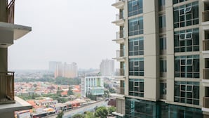 A high-rise building with multiple balconies and large windows. - Elegant And Comfy Studio At Tamansari Iswara Apartment (Bekasi)
