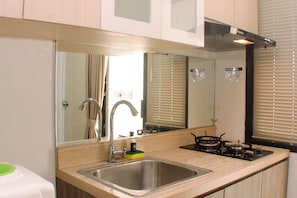 Studio | Private kitchen | Fridge, stovetop, cookware/dishes/utensils - Cozy Studio At Metropark Condominium Jabebeka Apartment (Cikarang)