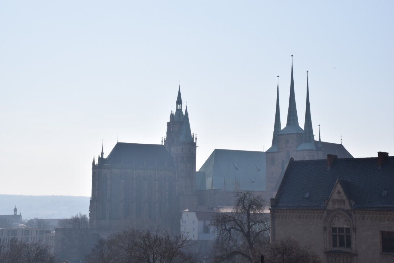 A historic building with multiple spires and a prominent central tower.